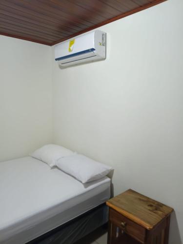 a bedroom with a bed and a nightstand with a heater at Hostal Calle Real in León