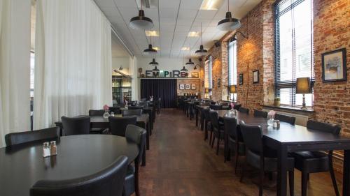 a row of tables and chairs in a restaurant at Best Western Hotel Herman Bang in Frederikshavn