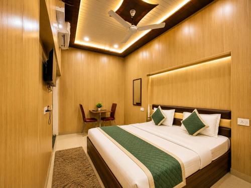 a hotel room with a bed and a table at HOTEL VARANASI DV - Near Shree Kashi Vishwanath Temple in Varanasi