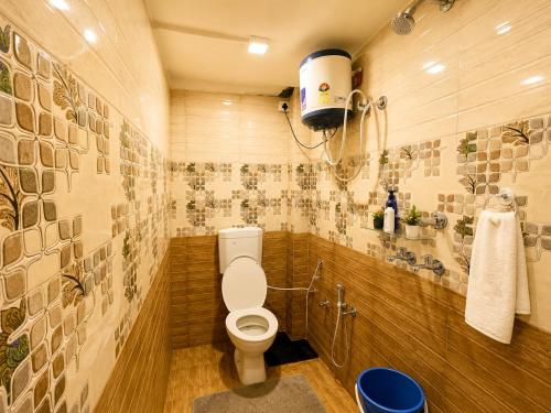 a bathroom with a toilet and a sink at HOTEL VARANASI DV - Near Shree Kashi Vishwanath Temple in Varanasi