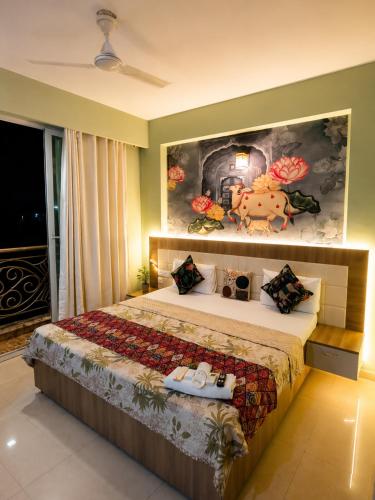 a bedroom with a bed with a painting on the wall at Lord krisna place --Near Prem Mandir & ISKCON in Vrindāvan