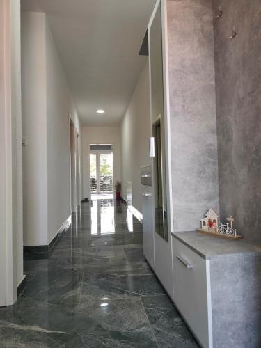 a hallway of a house with a glass door at Sokak Apartman in Bihać