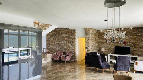 a living room with a couch and a table with chairs at Iztuzu Sunset Villa in Gökbel