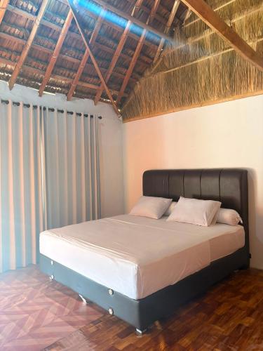 a bedroom with a bed in a room at Queen house in Waikabubak
