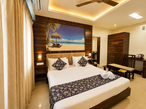 a hotel room with a bed and a desk at Hotel Rohit Rohini - New Aesthetic Hotel in Jagannath Puri with Restaurant, Parking, Free Wi-fi, Prime Location in Puri