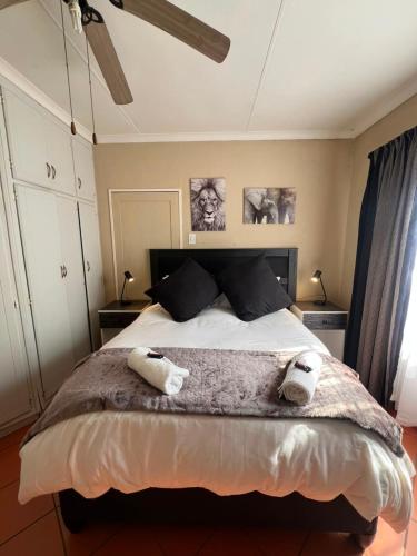 a bedroom with a large bed with two towels on it at Kingfisher Hideaway in Nelspruit
