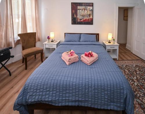 a bedroom with a bed with pink towels on it at Sunny Haven House in Jersey City