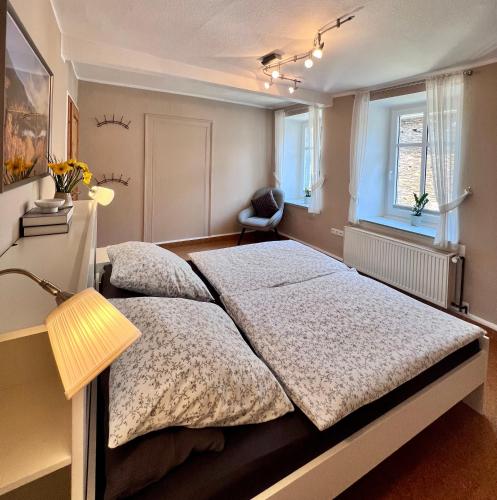 a bedroom with a large bed and a window at Ferienwohnung Haus Kreutz in Bruttig-Fankel
