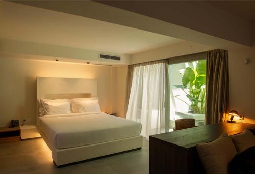 a bedroom with a bed and a large window at Anzo Villas in Oia