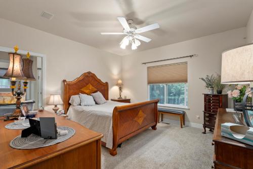 a bedroom with a bed and a desk with a laptop at Permana Apartment in Manila