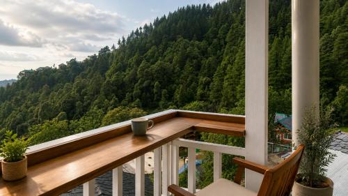 a balcony with a cup of coffee sitting on it at Le Refuge in McLeod Ganj