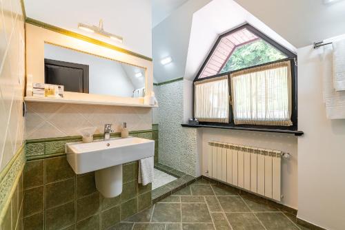 a bathroom with a sink and a window at Casa Freya in Buşteni