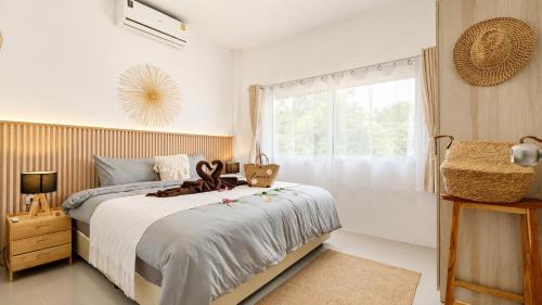 a bedroom with a bed with a teddy bear on it at Lavoe Villas Samui in Nathon Bay