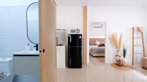 a kitchen with a black refrigerator in a room at Lavoe Villas Samui in Nathon Bay