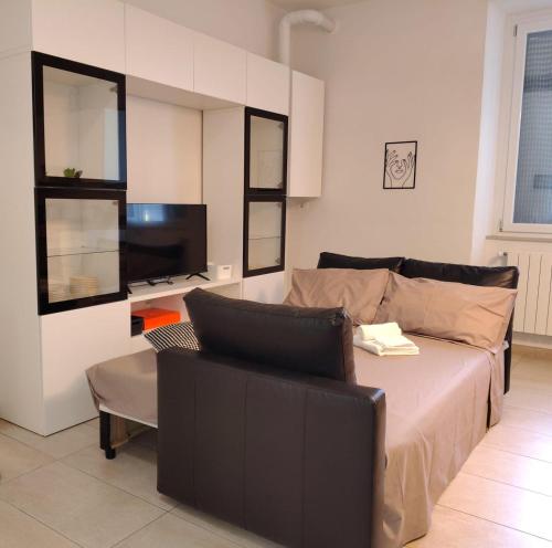 a living room with a bed and a couch at Albizi Home in Pontassieve