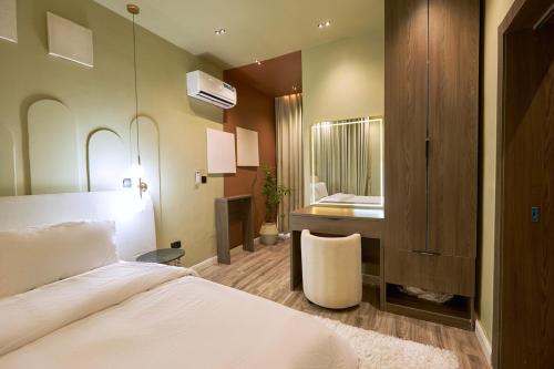 a bedroom with a white bed and a sink at The Chevron House in Ikuata