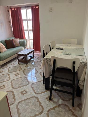 a living room with a table and a couch at Depto hube in La Banda