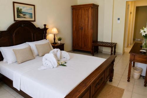 a bedroom with a large bed with a white towel on it at Galini Hotel in Agia Marina Aegina