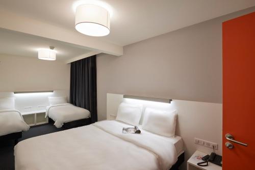 Un pat sau paturi într-o cameră la Le Nex2