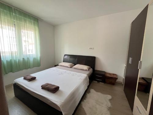 a bedroom with a bed with two towels on it at Rayand in Mostar