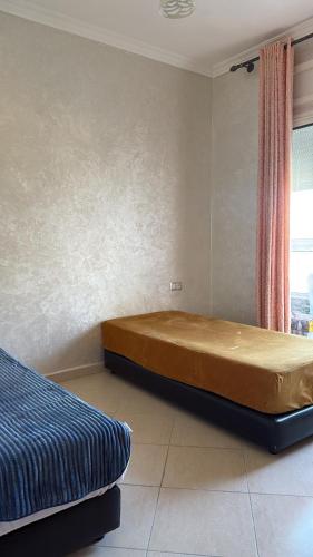 a bedroom with a bed and a window at Chez Iceyy in Tangier