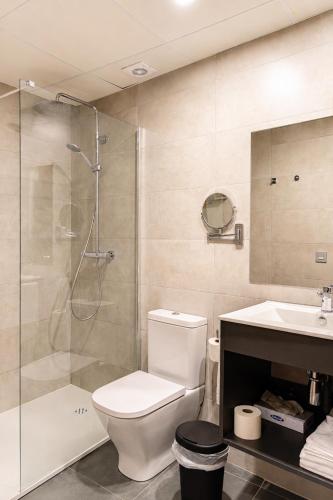a bathroom with a shower and a toilet and a sink at Tudel in Andorra la Vella