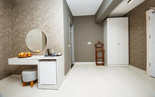 a bathroom with a sink and a mirror on the wall at Guney House by Villa Safiya in Fethiye