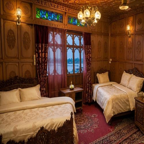a bedroom with two beds and a window at Kashmir View group of Houseboat in Srinagar