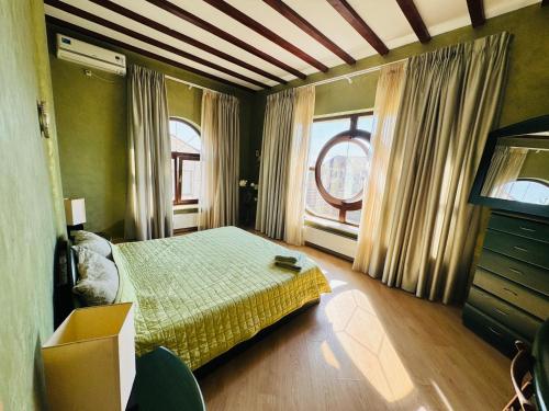 a bedroom with a bed and a large window at Дом Каролино-Бугаз у моря in Zatoka