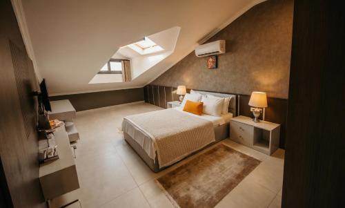 a attic bedroom with a bed and a window at Guney House by Villa Safiya in Fethiye