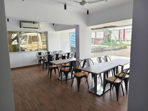 a group of tables and chairs in a room at The Moon Hotel Panvel in Āpta