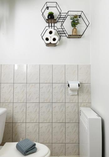a bathroom with a white toilet and a sink at Studio Catherine in Sainte-Céronne-lès-Mortagne