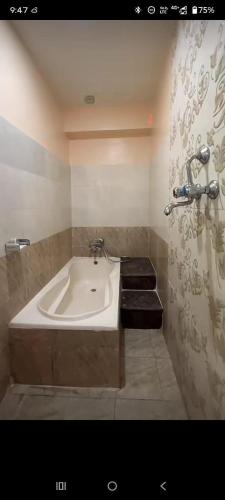 a bathroom with a bath tub in a room at Hotel Royal Inn in Nawākot