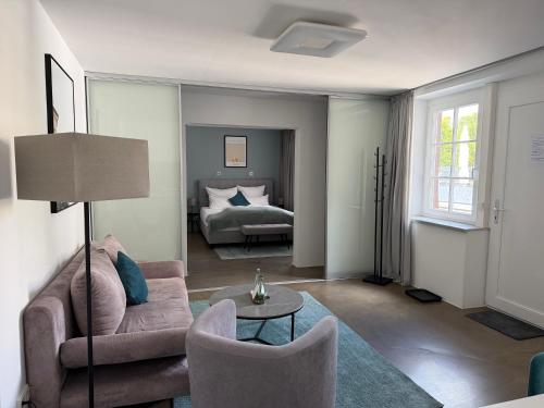 a living room with a couch and a bed at Rotmain Apartments in Bayreuth