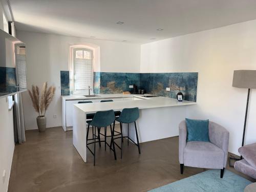 a kitchen with a counter and chairs in a room at Rotmain Apartments in Bayreuth