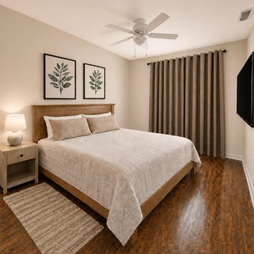 a bedroom with a bed and a ceiling fan at TIMBER TRAIL RETREAT in Steamboat Springs