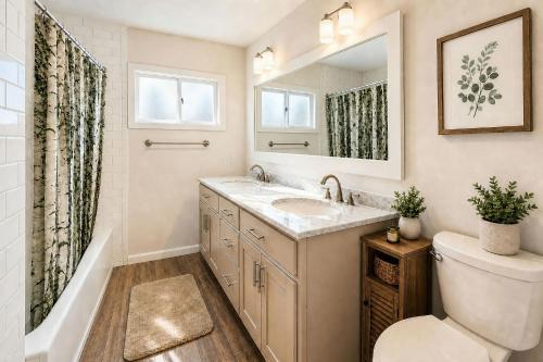 a bathroom with a sink and a toilet and a mirror at TIMBER TRAIL RETREAT in Steamboat Springs