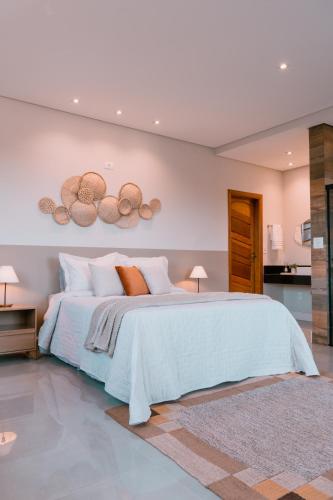 a bedroom with a large bed in a room at Chalé Refúgio Fegama in Passa Quatro