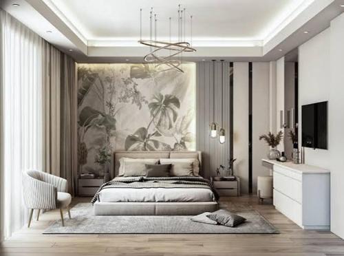 a bedroom with a large bed and a chandelier at CHINDU HOUSE Inn in Chennai