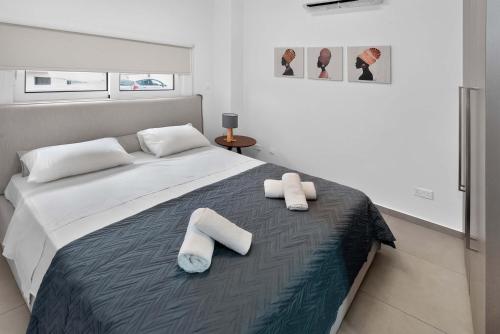 a bedroom with a bed with two towels on it at Sun & Moon Luxury - Celeste Villa in Ayia Napa