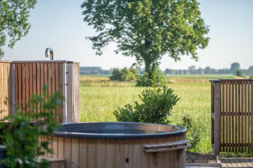 a hot tub in a yard next to a field at Maison Bellevue in Westendorf