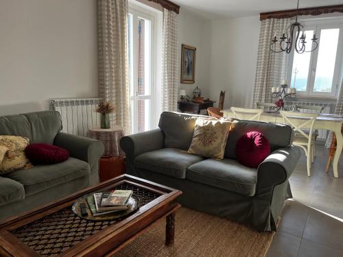 a living room with two couches and a coffee table at Il Refolo in Norcia