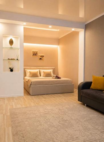 a bedroom with a bed and a couch at Кошкарбаева 58 in Kokshetau