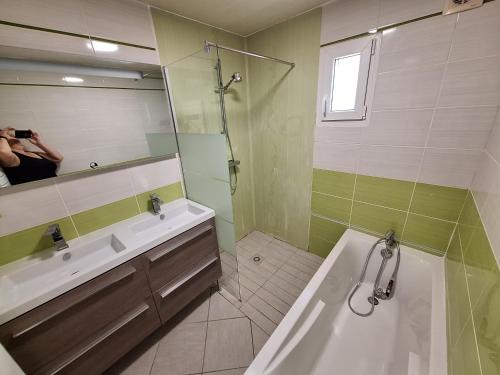 a person taking a picture of a bathroom with a tub and sink at Gite de la véore in Chabeuil