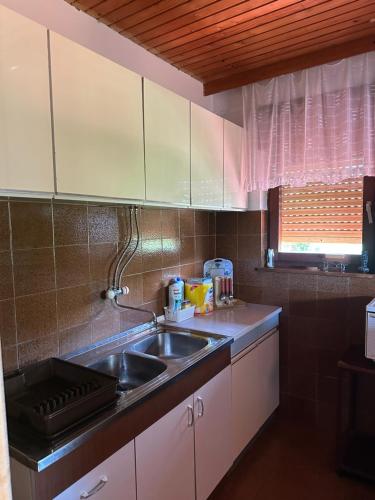 a kitchen with a sink and a counter top at Vila Popovski in Ljubaništa