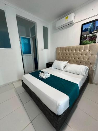 a bedroom with a large bed in a room at Hotel Rodadero Suites By SGH in Santa Marta