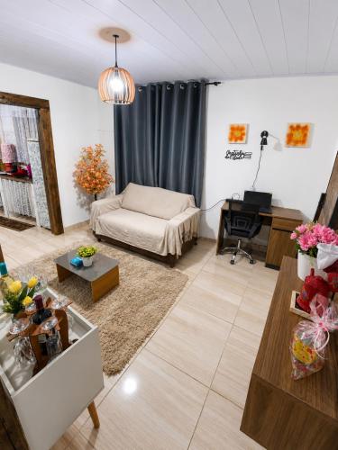 a living room with a couch and a table at Pousada Estância Bela Vista in Santa Teresa