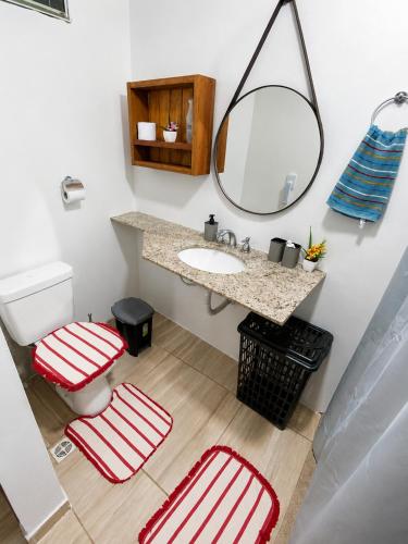 a bathroom with a sink and a mirror and two stools at Pousada Estância Bela Vista in Santa Teresa