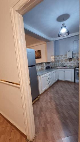 a large kitchen with a refrigerator in a room at F3 de luxueux in Bejaïa