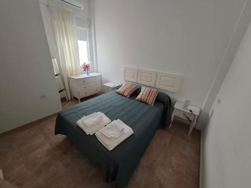 a bedroom with a bed with two towels on it at Casa turística AZAHAR in Villablanca